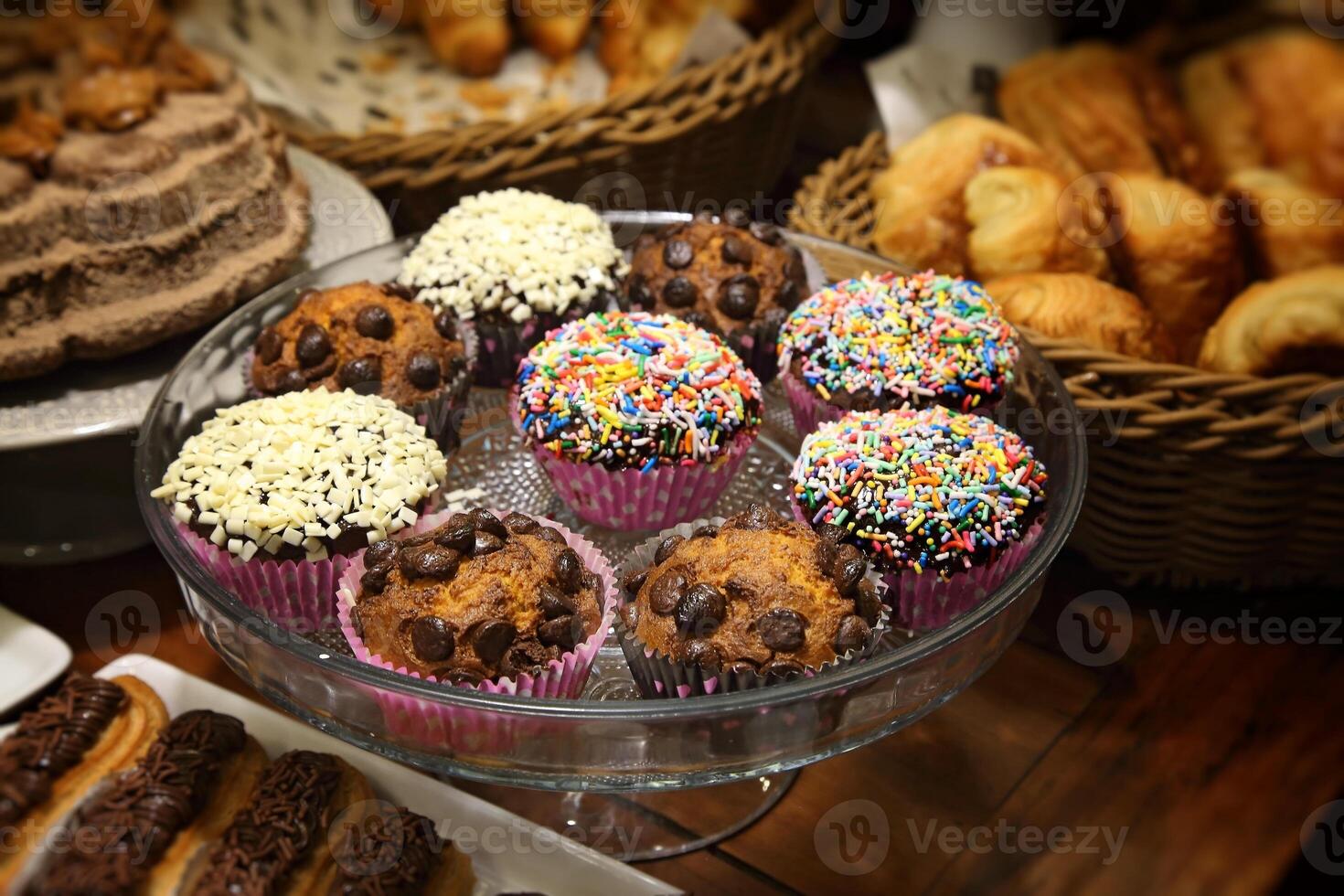 delicious chocolate muffins in tray on wooden table photo