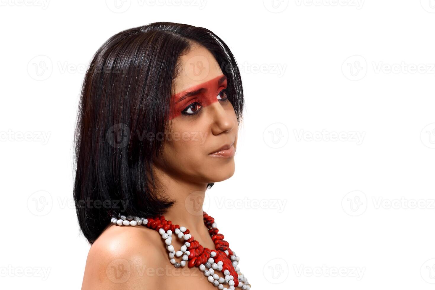 smiling brunette model in Brazilian Indian costume and makeup holding a tapioca, a typical Brazilian snack photo