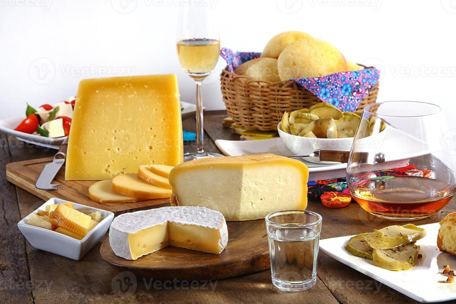wooden table with snacks, fruits and cheeses to be tasted with pinga, the famous Brazilian brandy photo