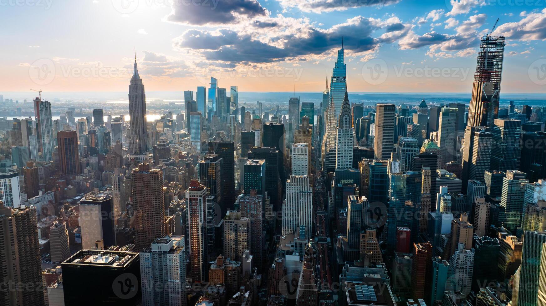 Skyline of modern New York, the USA. Majestic skyscrapers on the waterfront under the cloudy sky at daytime. photo
