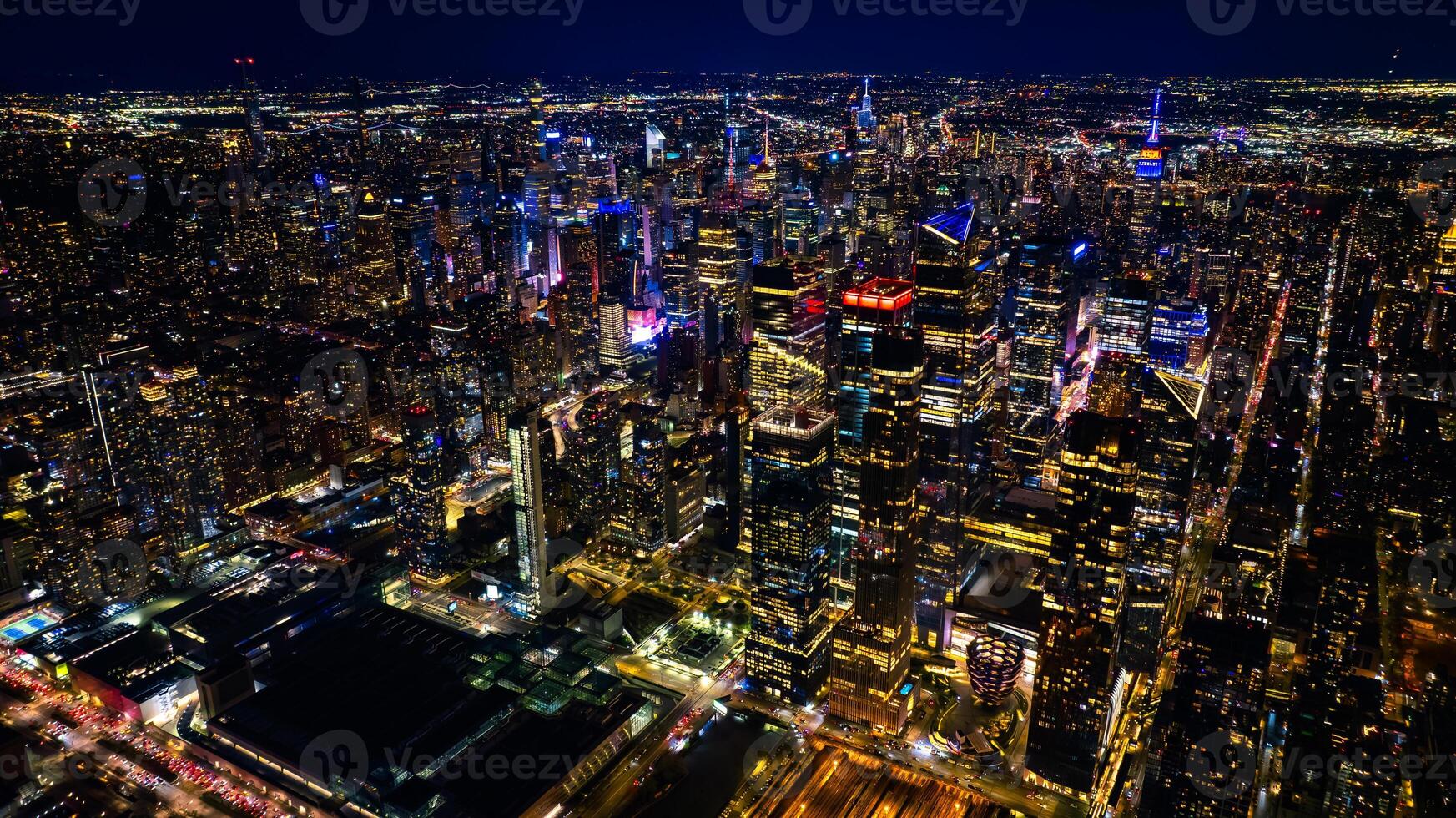 Night scenery of New York, the USA with fantastic illumination. Skyscrapers in the scenery of metropolis are dazzling and sparkling with lights. Top view. photo