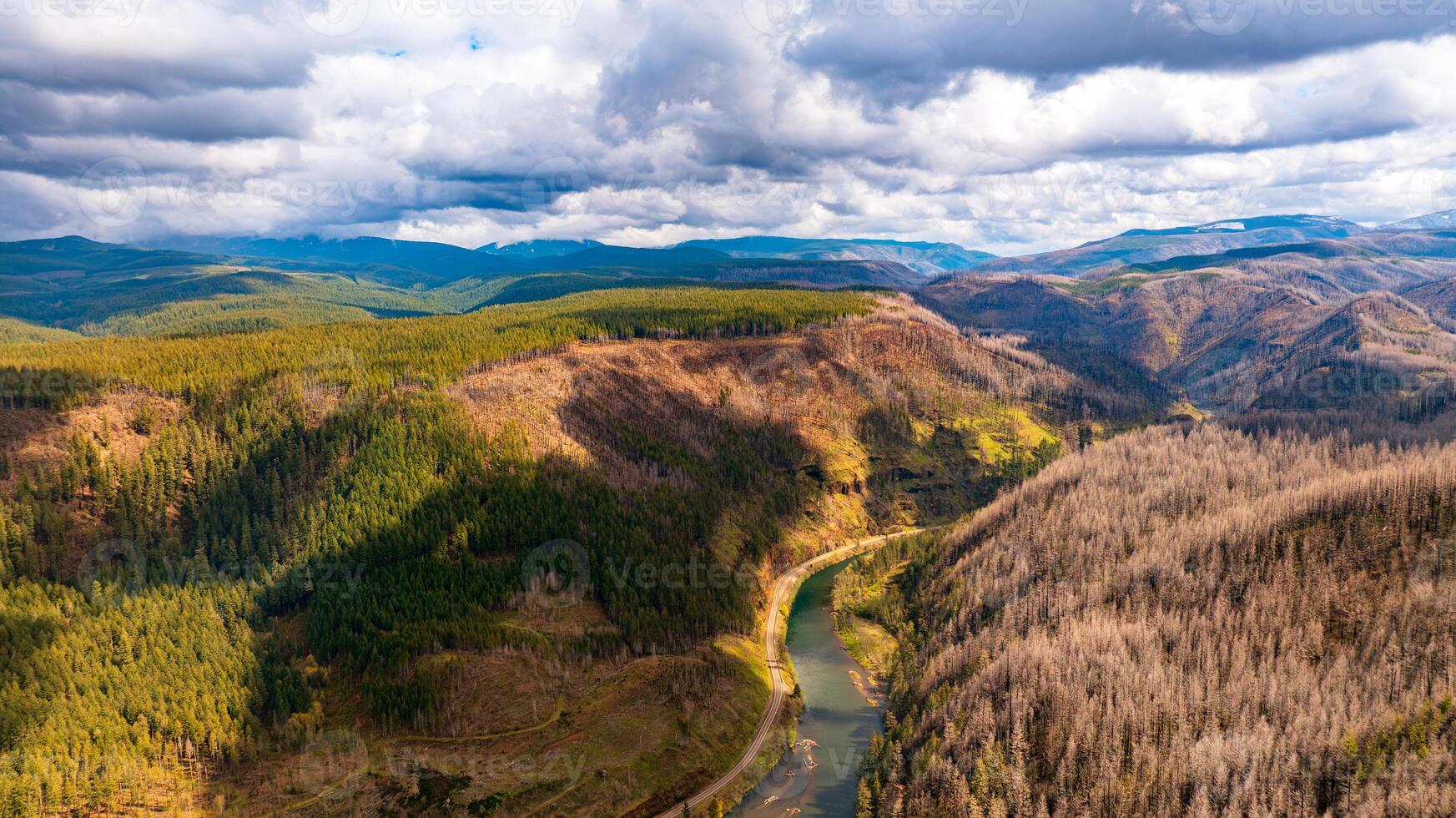 Spectacular view of mountains and river in the wilderness of Oregon State, the USA. Mt. Hood National Forest. Grey rainy clouds overcast the sky above the landscape. Top perspective. photo