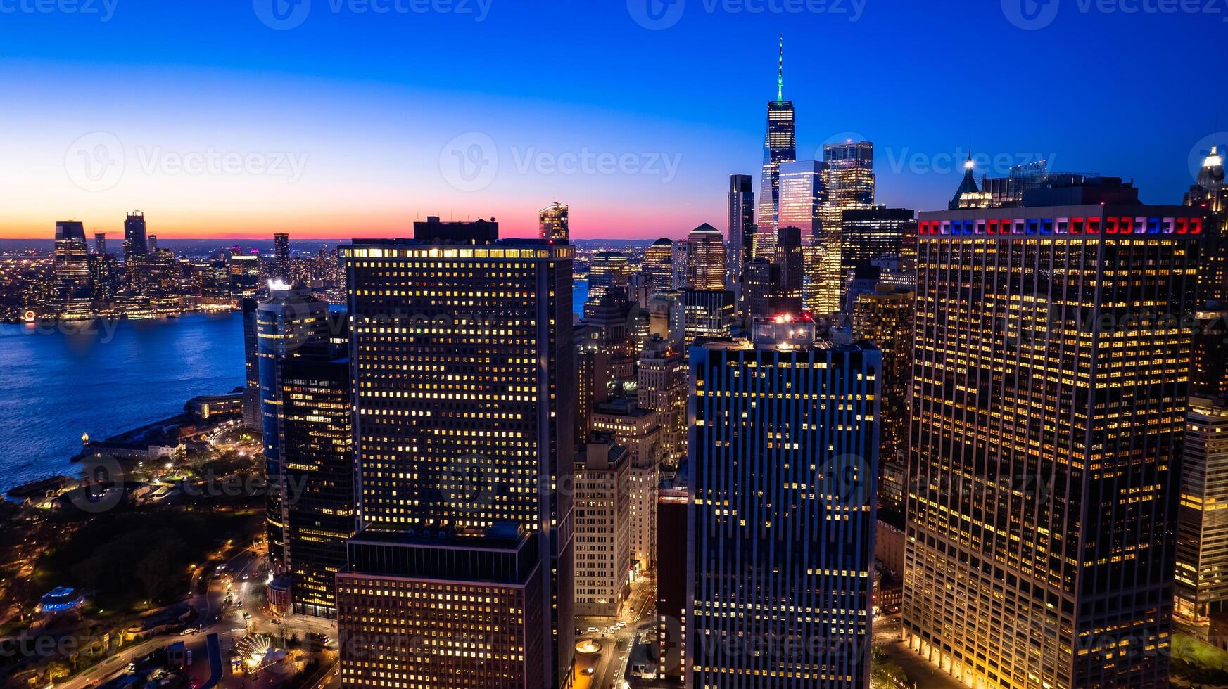 Beautiful city view with multiple lights on. New York panorama from drone photo above the East River. Aerial view.