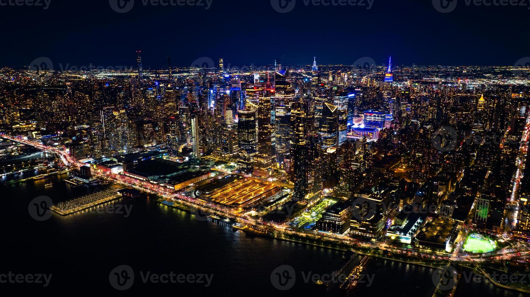 Night scenery of New York, the USA with fantastic illumination. Skyscrapers in the scenery of metropolis are dazzling and sparkling with lights. Top view. photo