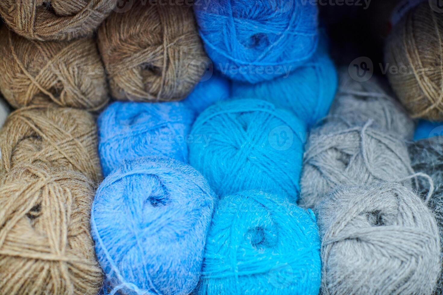 Colored blue brown yarn balls in knitting shop, macro photo
