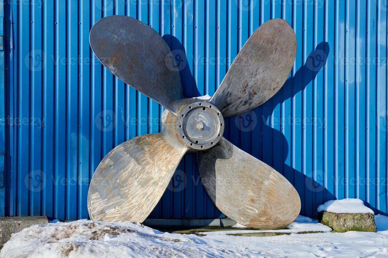 Old boat propeller deteriorate in boat yard photo