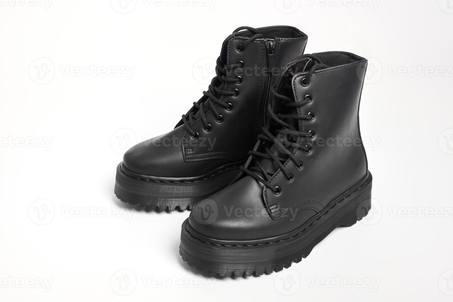 Black women combat boots on high heel platform with lug soles on isolated white background photo