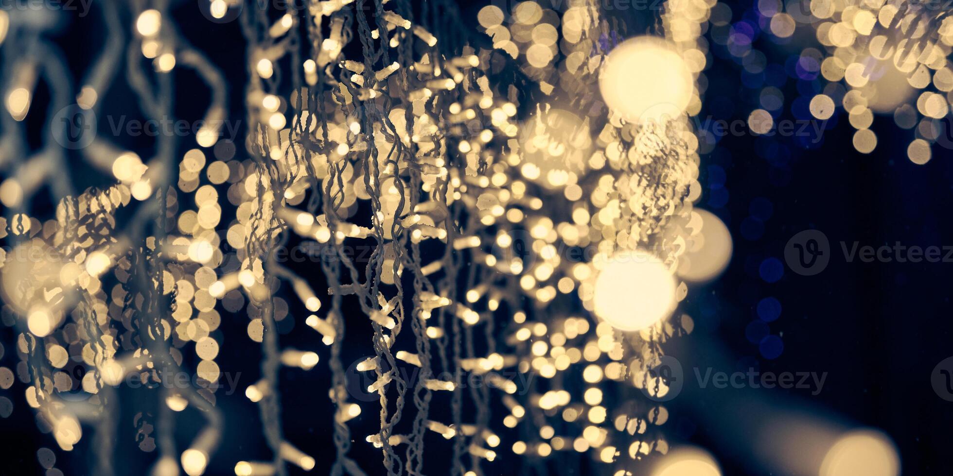 Pale yellow lights bokeh from christmas holiday garlands, blurred festive abstract background lights photo