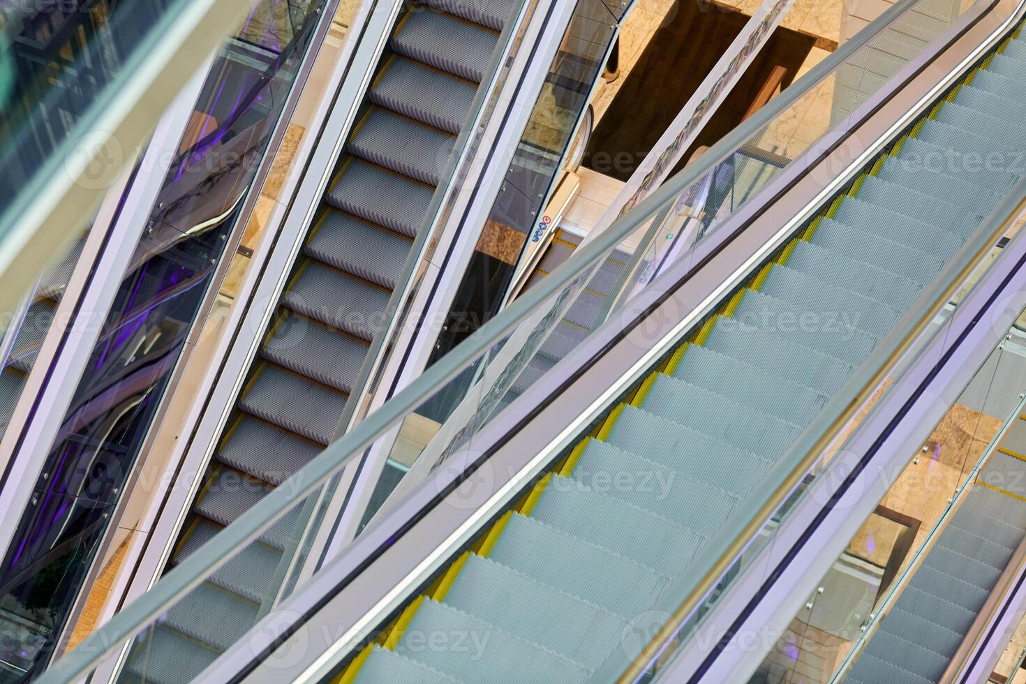Crisscross escalators in shopping center photo