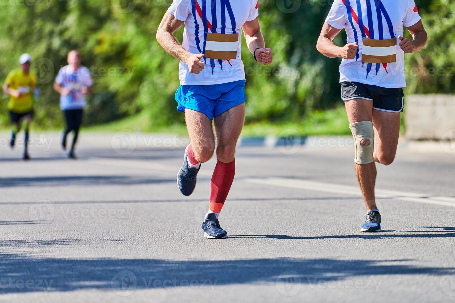 Marathon runners on city road. photo
