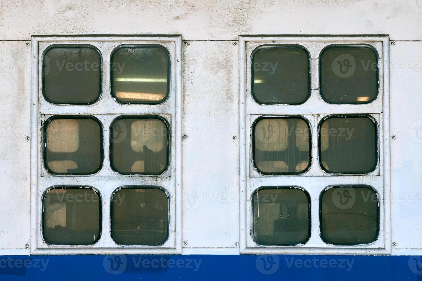 Two cabin windows and portholes on outboard side of ship photo