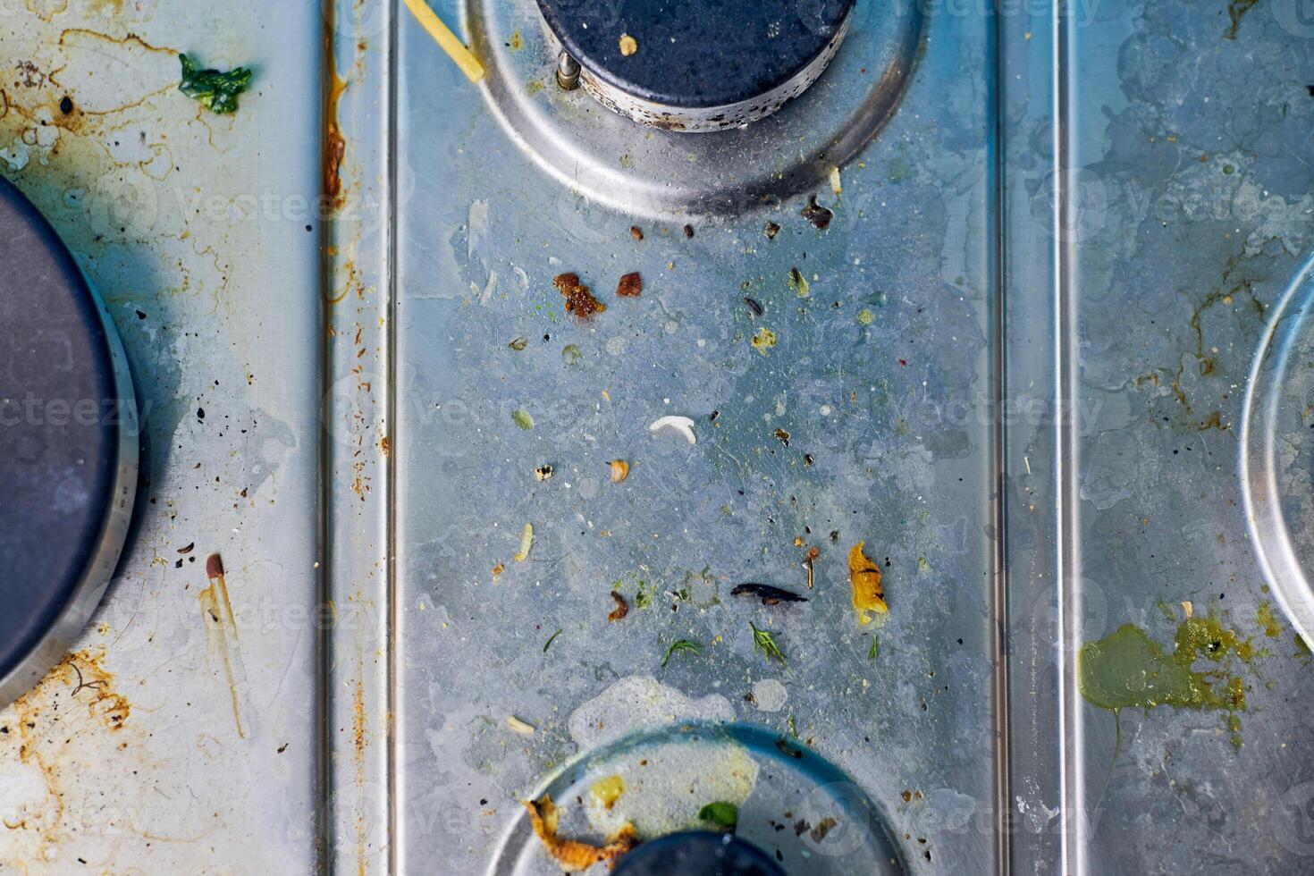 Dirty gas stove with food leftovers and crumbs photo
