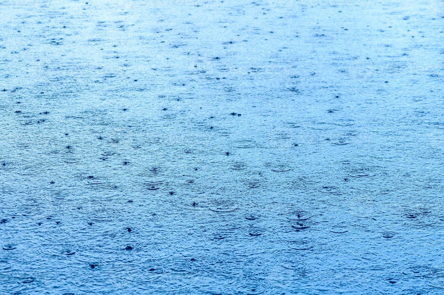 Defocus blurred transparent blue colored clear calm water surface texture with splashes and bubbles.3 photo