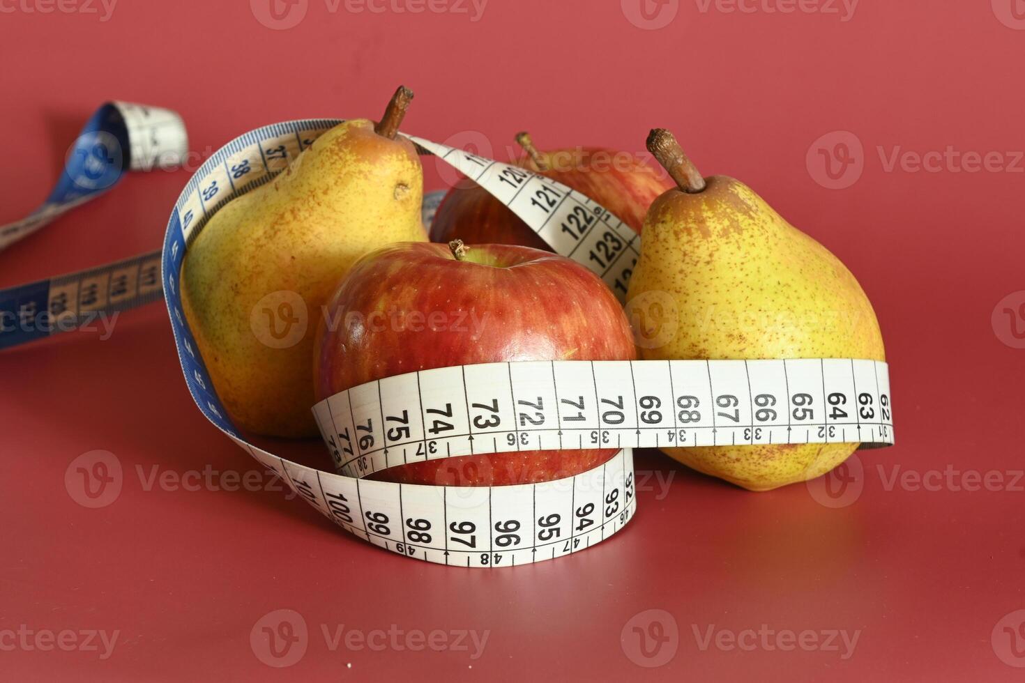 Tape measure and apple symbolizing diet and obesity photo