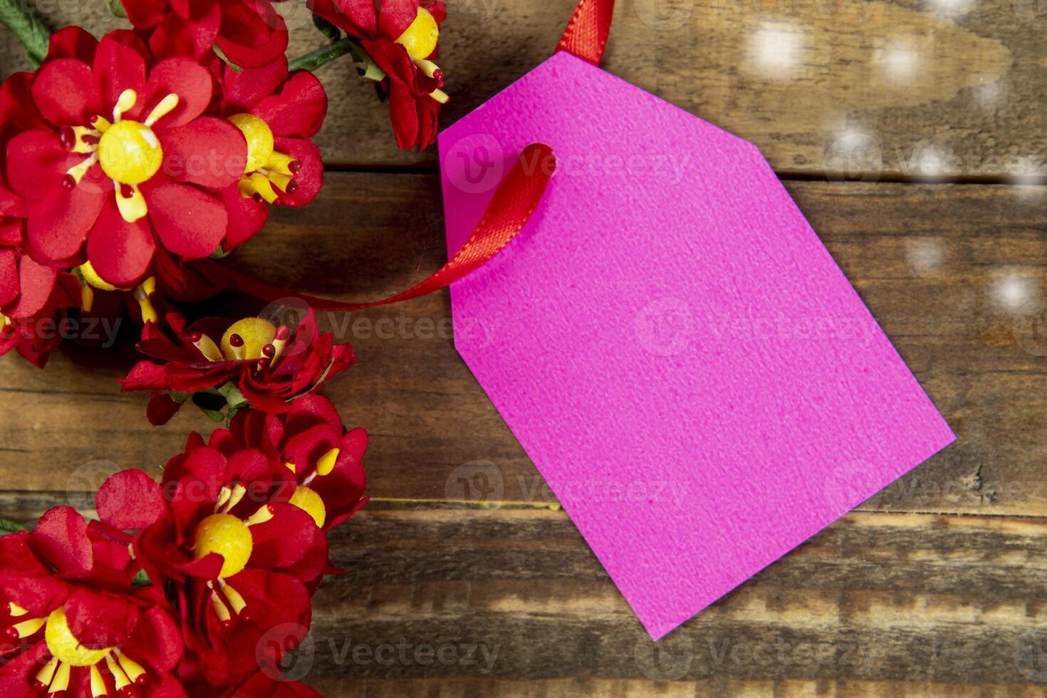 decorative christmas elements next to card with red ribbon and space to write photo