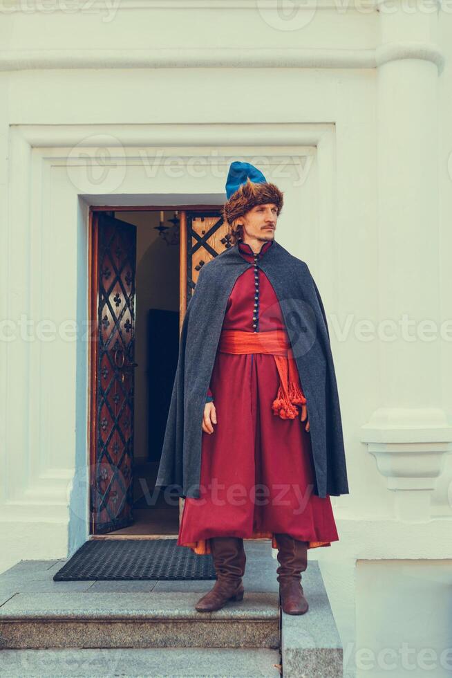 Portrait of a man in a medieval middle class costume. Retro style and historical clothes concepts photo