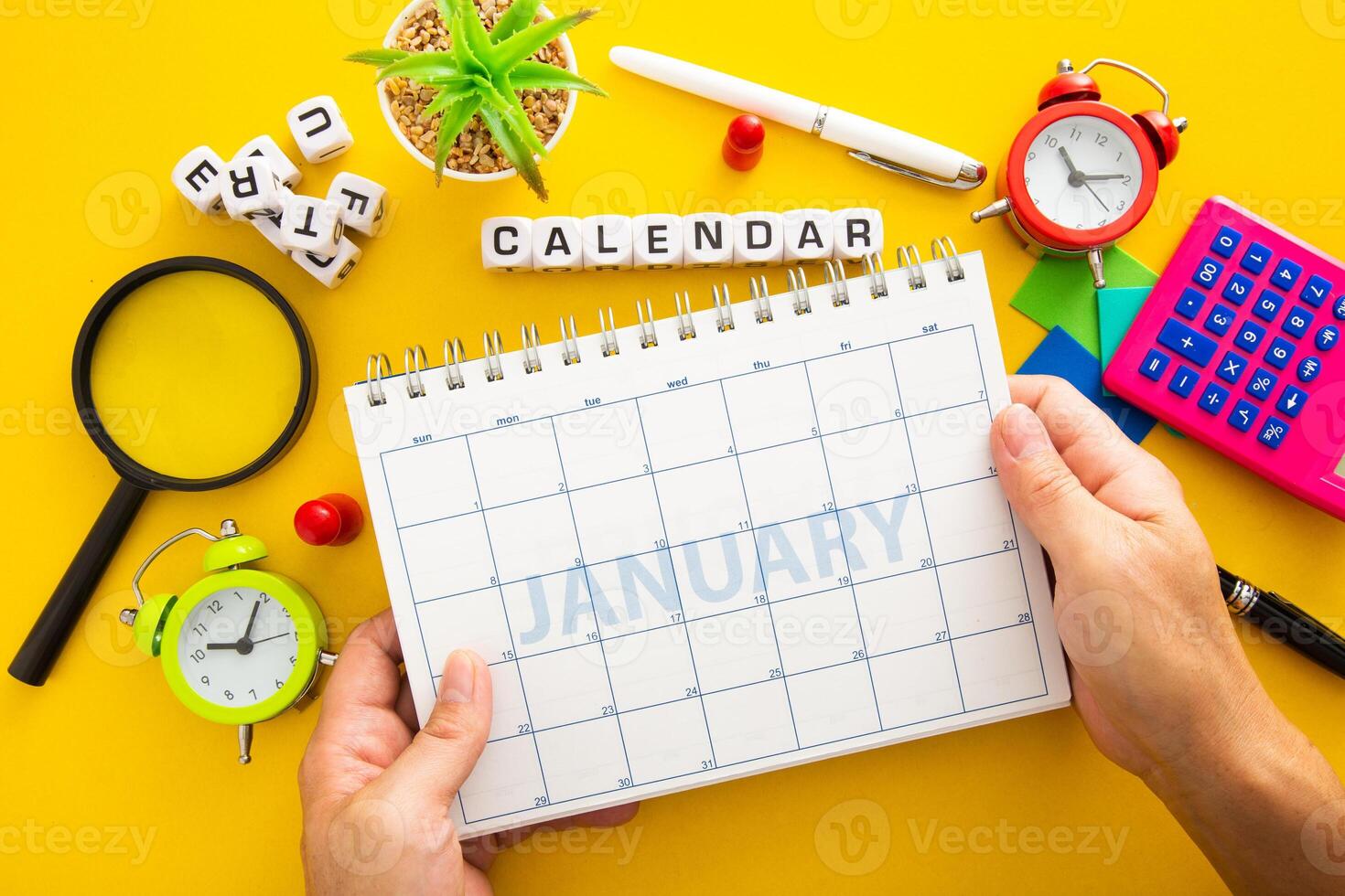 Hand holding a planner showing month of January photo
