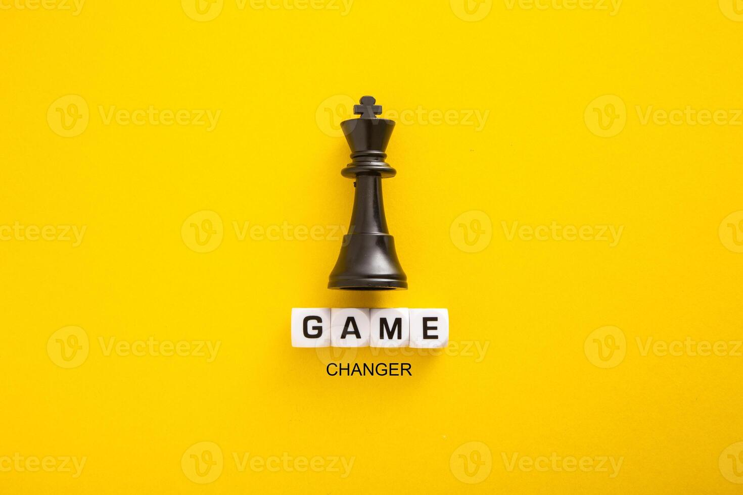 Block Letters and King Icon on yellow Background. Game Changer Concept. photo