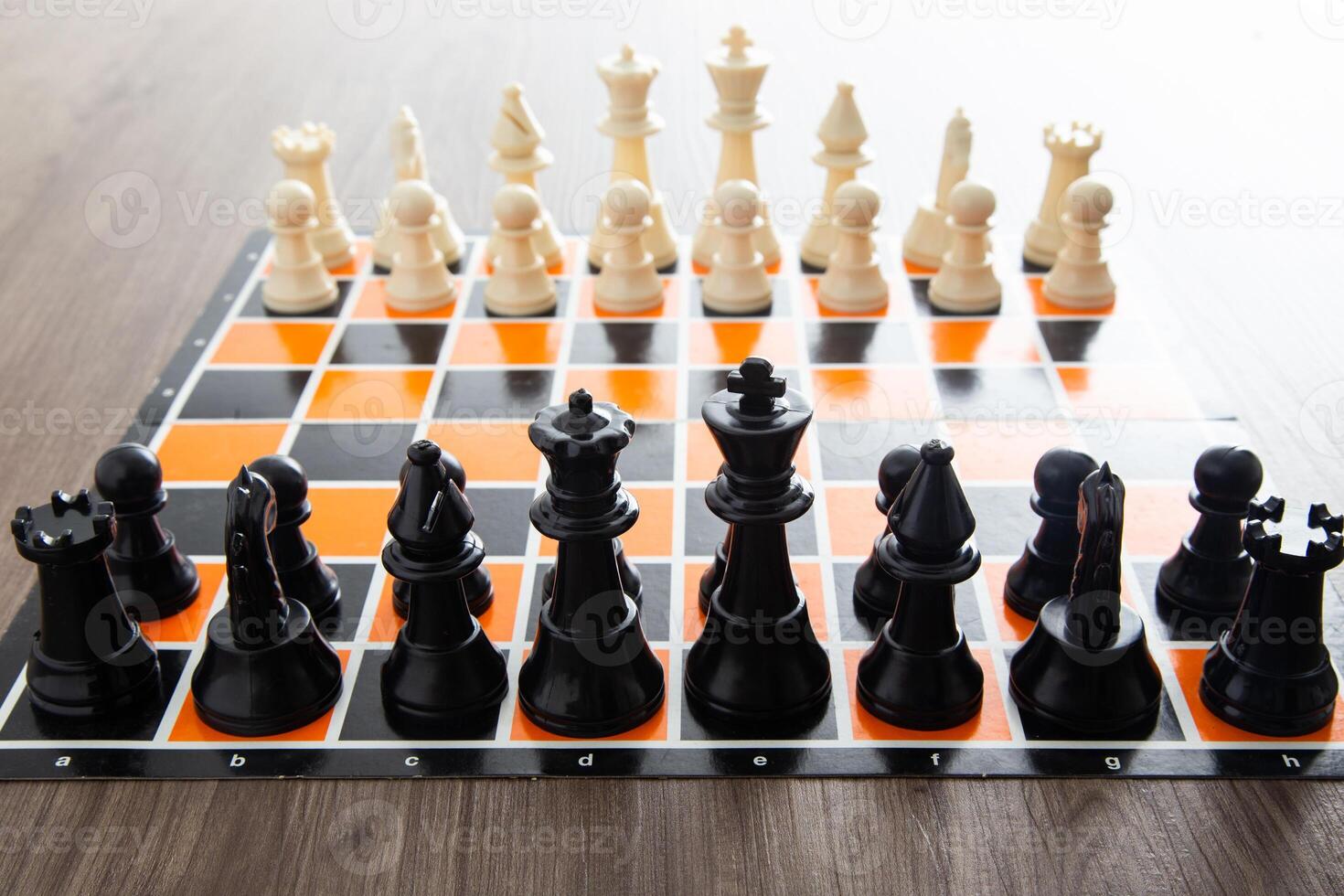 Chess board game on wooden table photo
