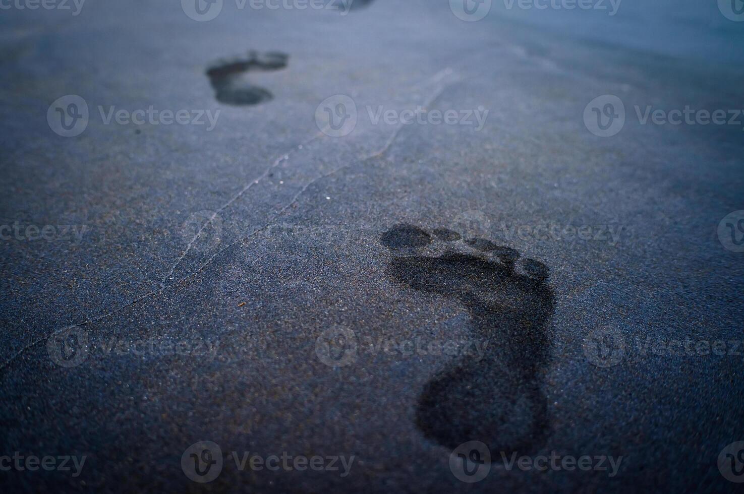 soles of feet, footprints on the beach sand photo