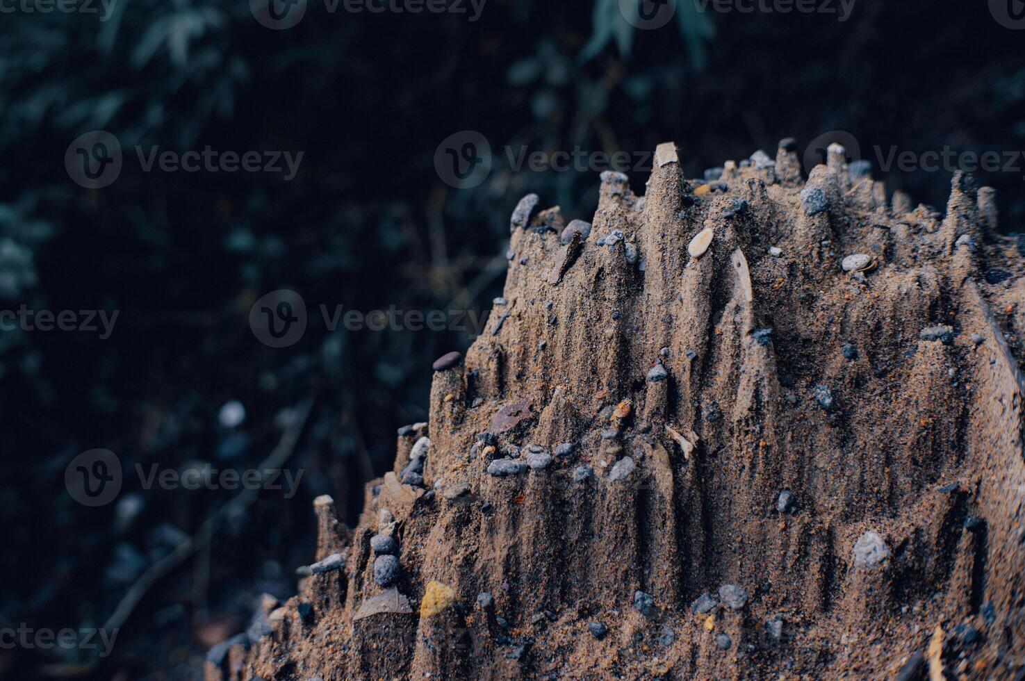 piles of sand exposed to rainwater look like miniature cliffs and mountains photo