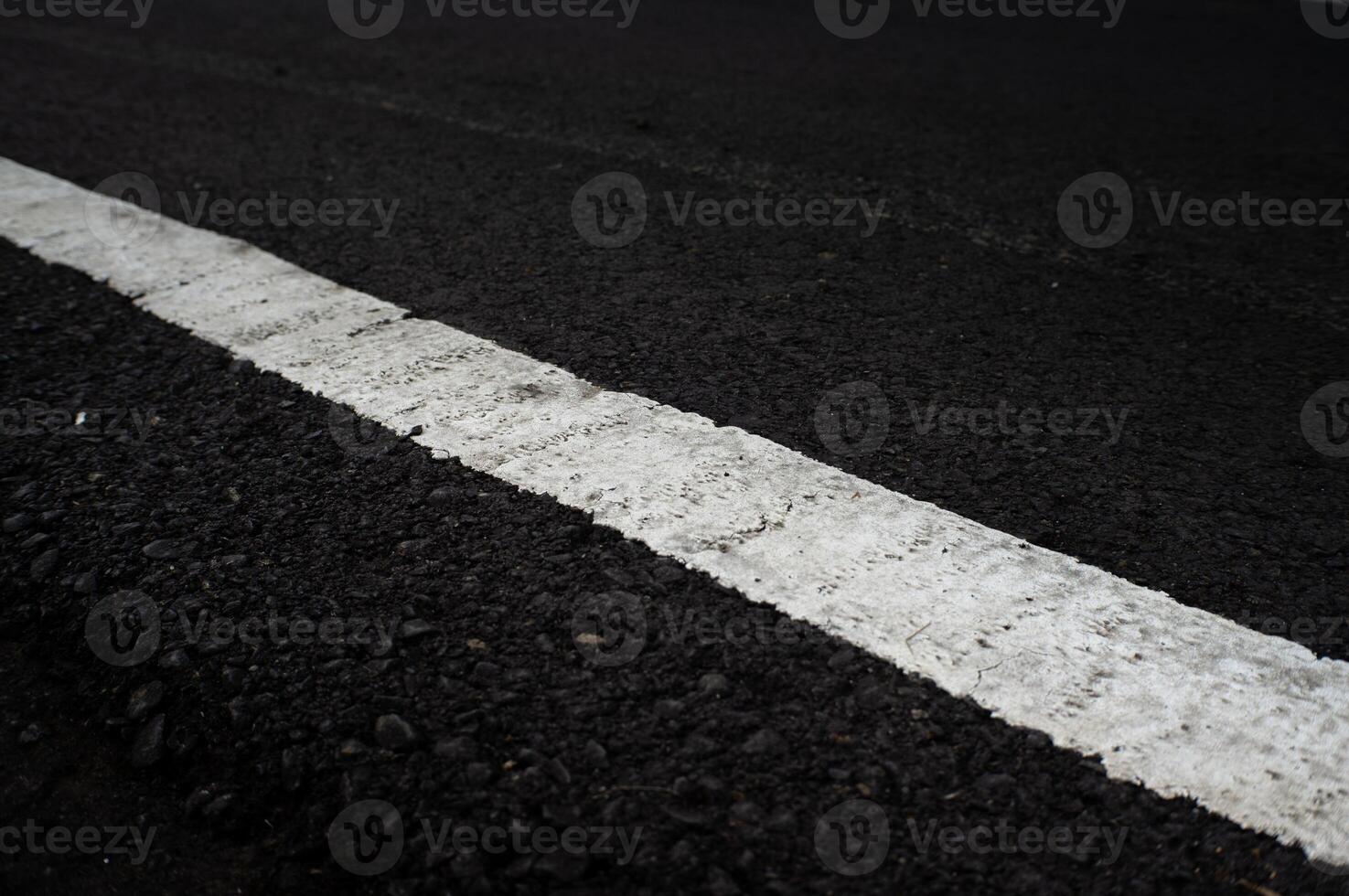 white road markings on asphalt road photo