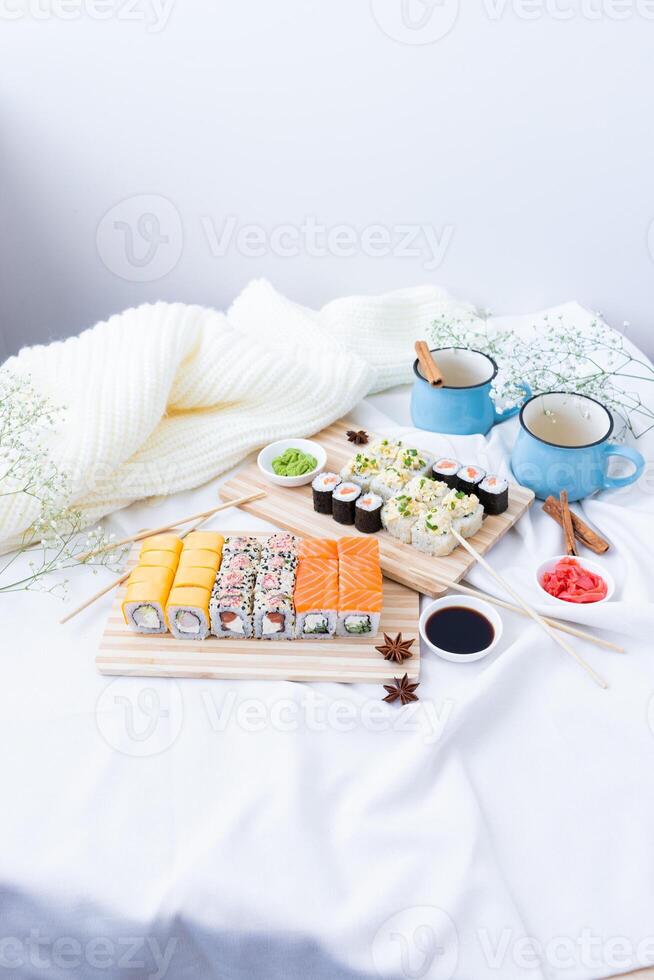 Sushi delivery. Set of rolls in a disposable box on a black background. Top view photo