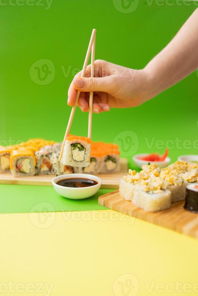 Sushi delivery. Set of rolls in a disposable box on a black background. Top view photo