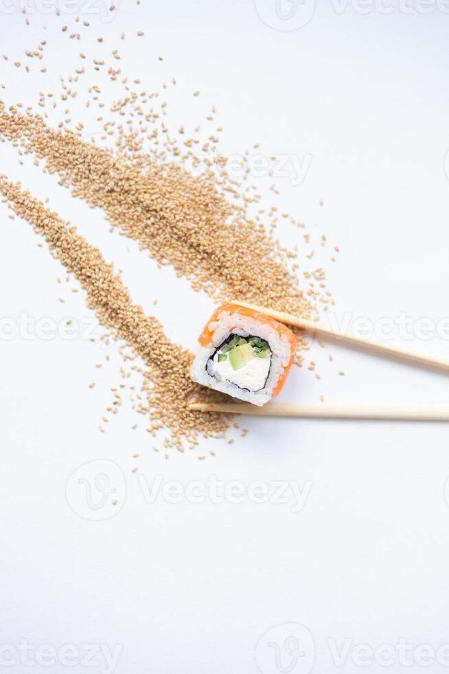 Sushi delivery. Set of rolls in a disposable box on a black background. Top view photo
