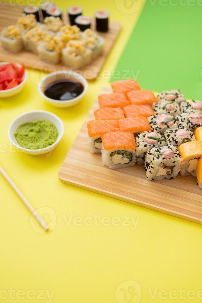 Sushi delivery. Set of rolls in a disposable box on a black background. Top view photo