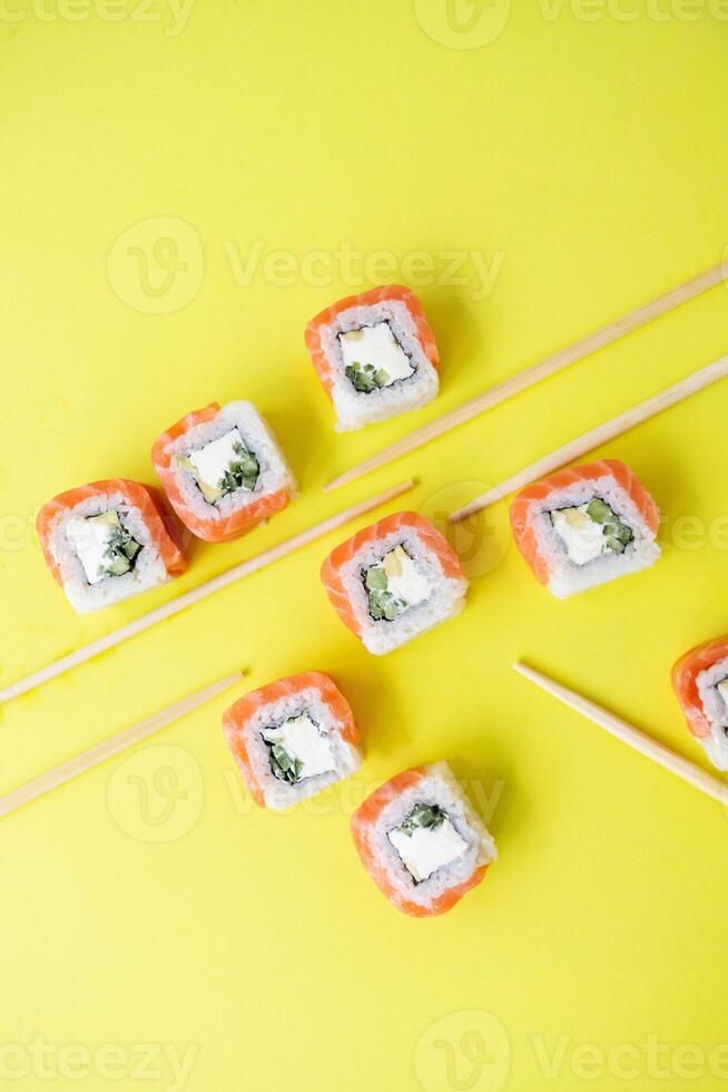 Sushi delivery. Set of rolls in a disposable box on a black background. Top view photo