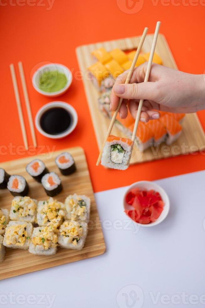 Sushi delivery. Set of rolls in a disposable box on a black background. Top view photo