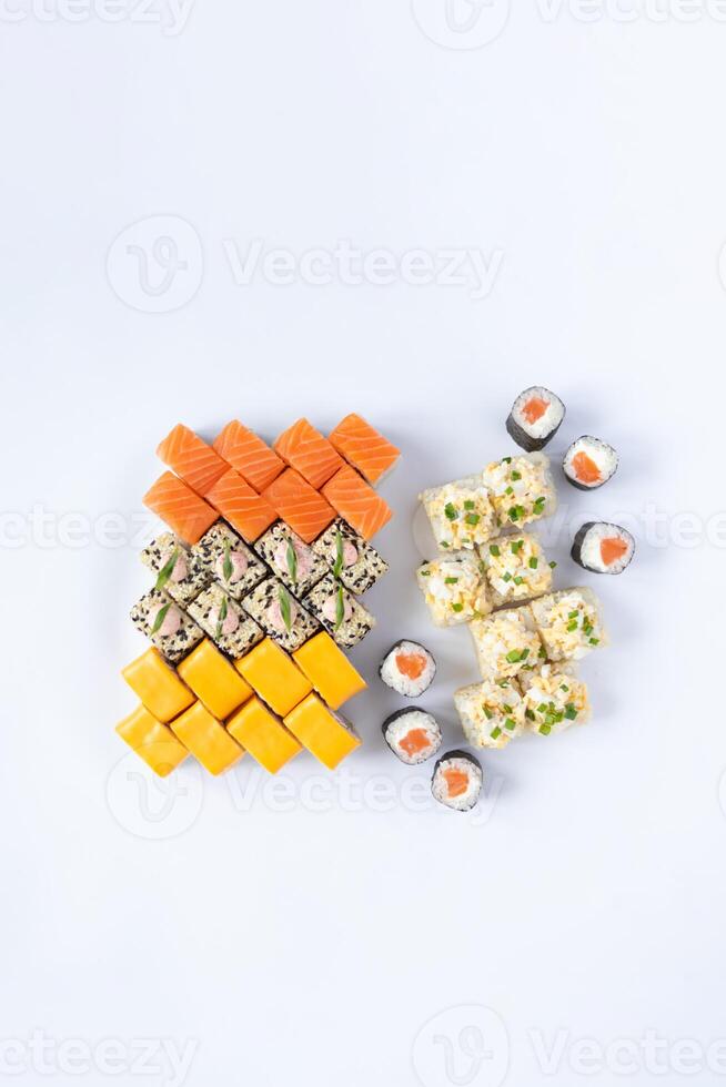 Sushi delivery. Set of rolls in a disposable box on a black background. Top view photo
