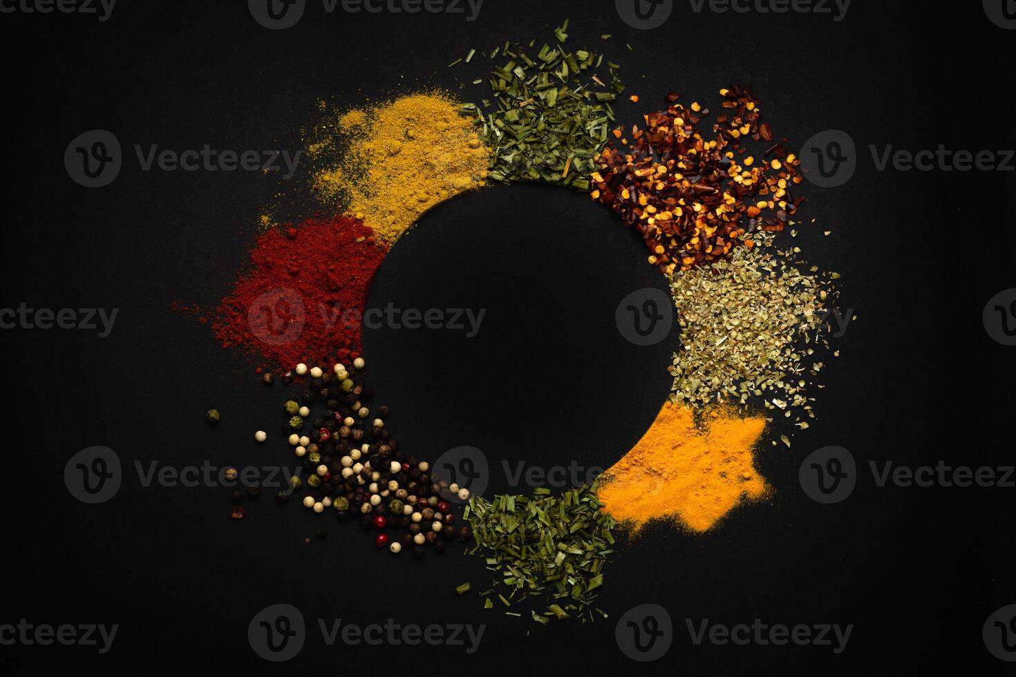 Curry pile, caribbean spice blend, mix ground turmeric, fenugreek, coriander, ginger, cumin, allspice, chili, nutmeg, cardamom on isolated black, top view photo
