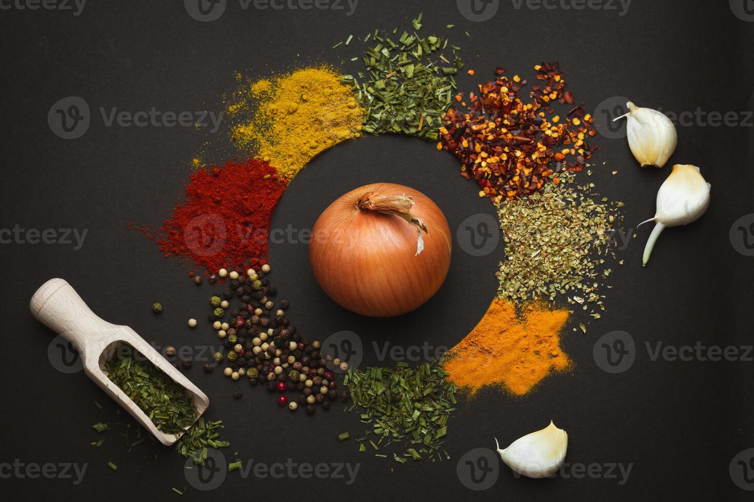 Circle frame composition of spices and herbs isolated on dark background with copy space. Frame of Indian spices and herbs. Ingredients of asian cuisine spices photo