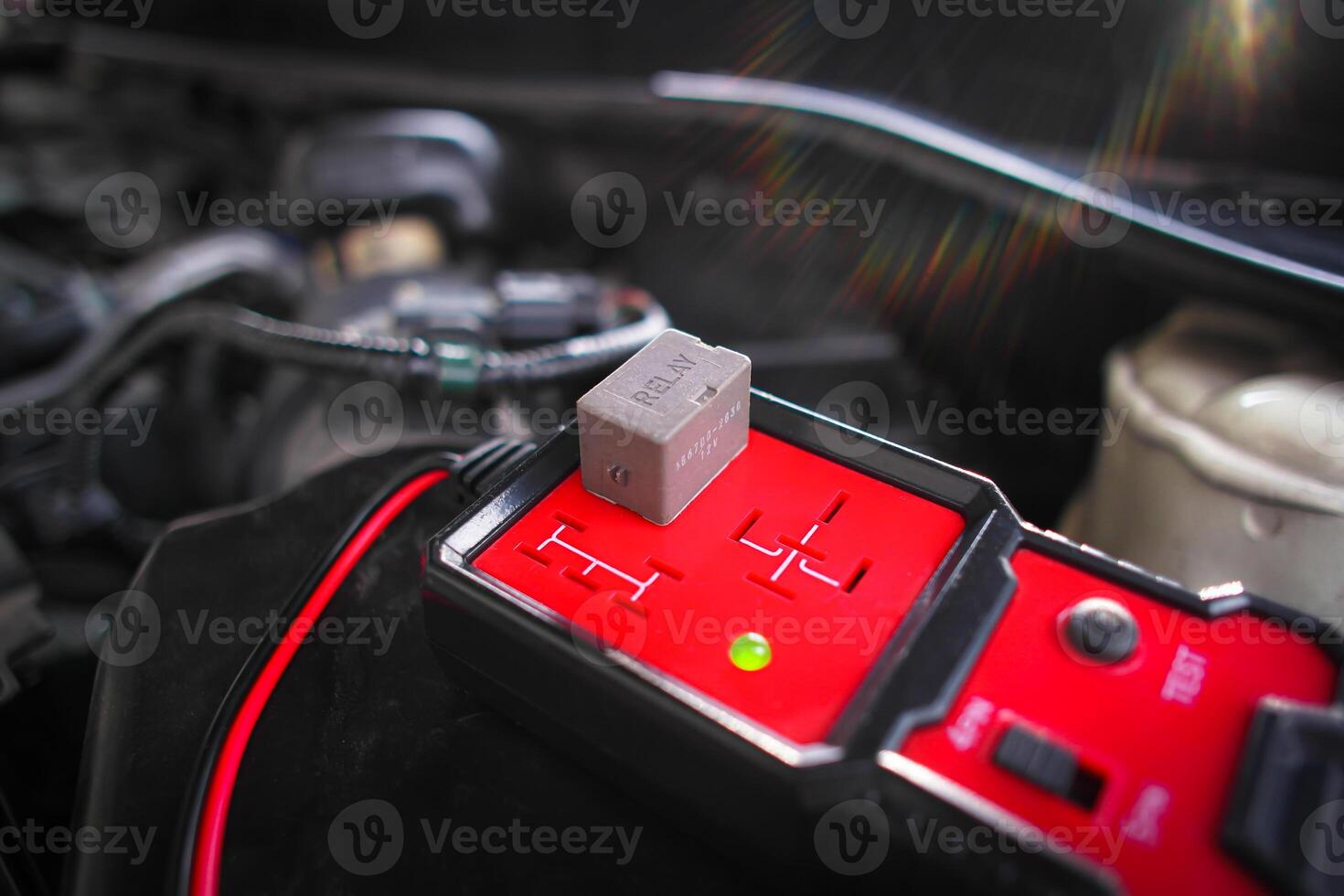Car relay testing with a relay tester for system test , Car maintenance and repair servicing concept photo