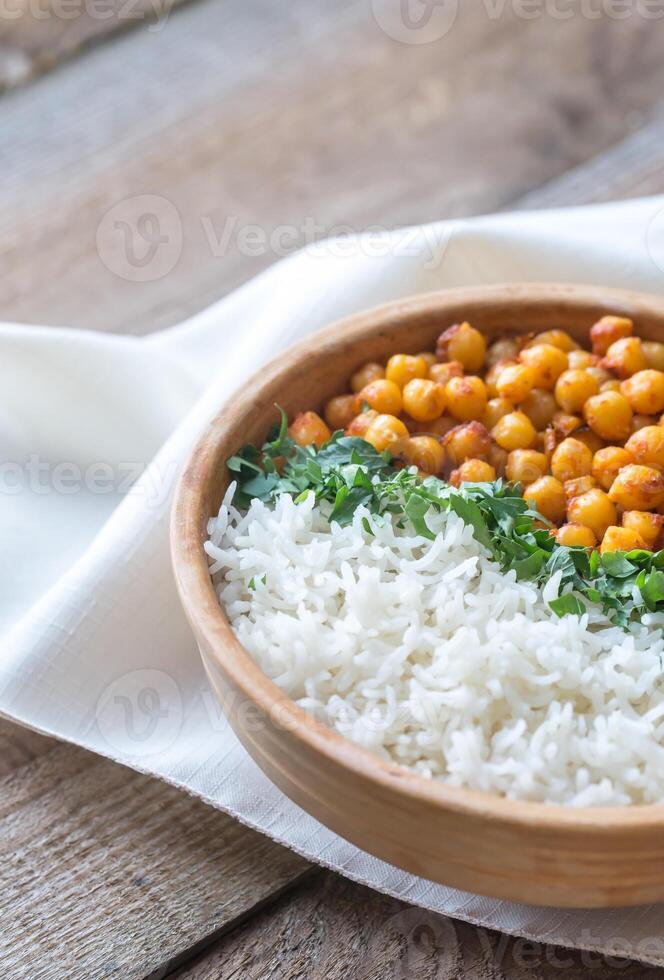 Bowl of chickpea curry with white rice and fresh cilantro photo