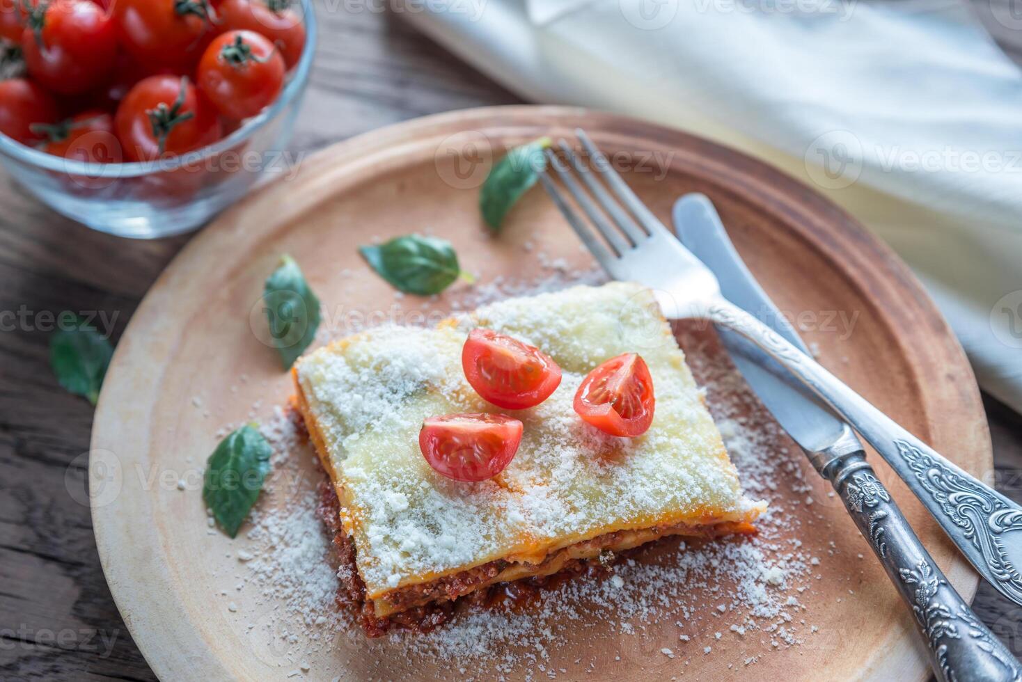 Lasagna with cherry tomatoes and fresh basil photo