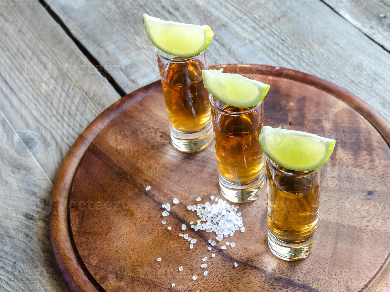 Glasses of tequila on the wooden board photo