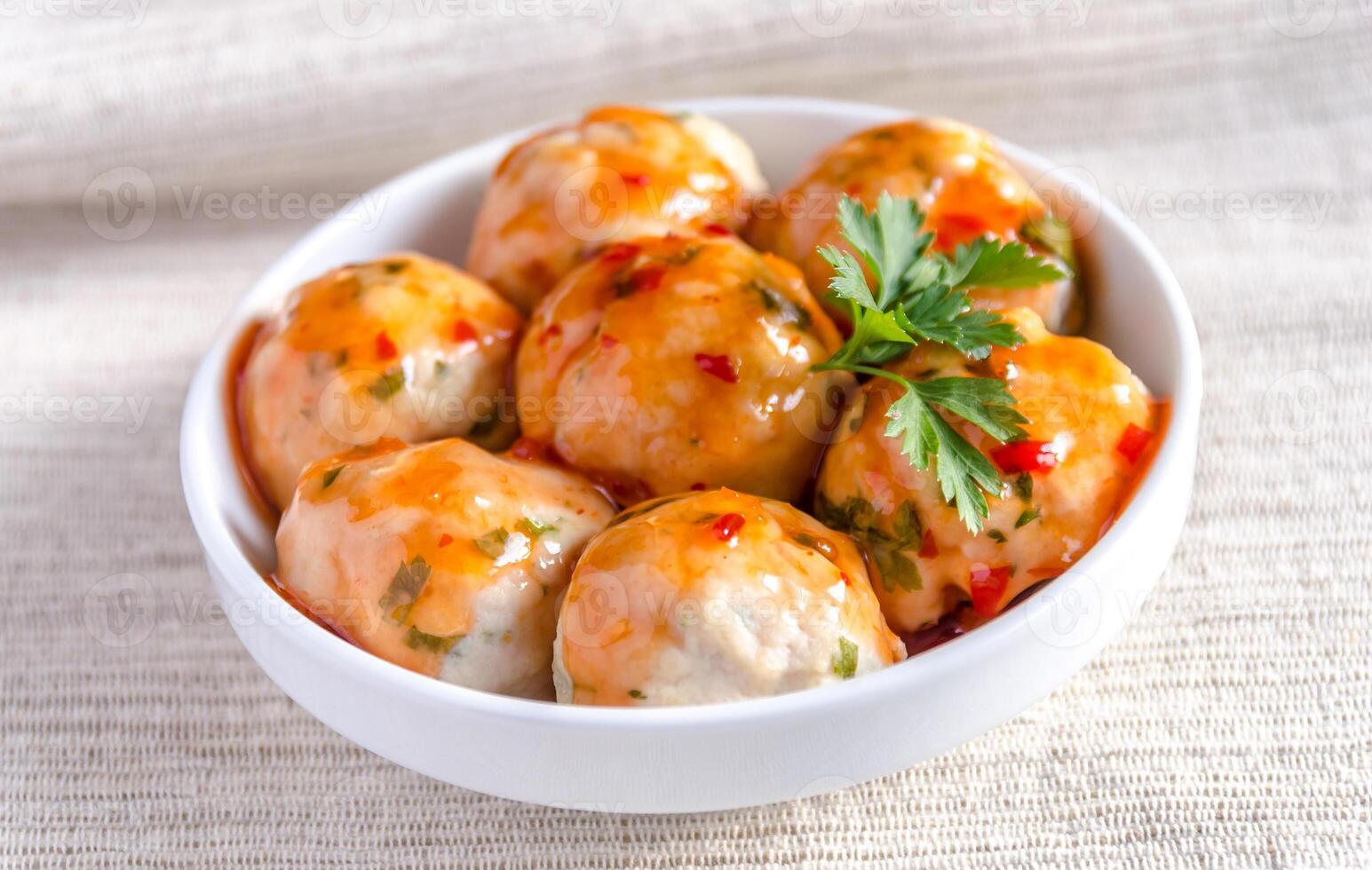 Chicken meatballs with parmesan under spicy sauce photo
