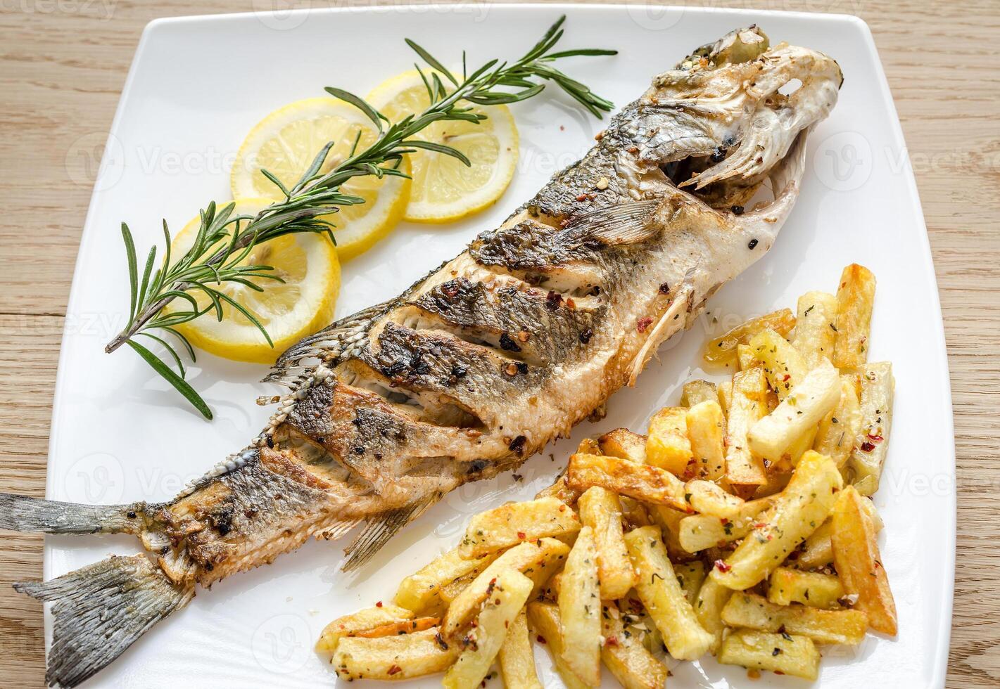 Baked seabass with fried potatoes photo