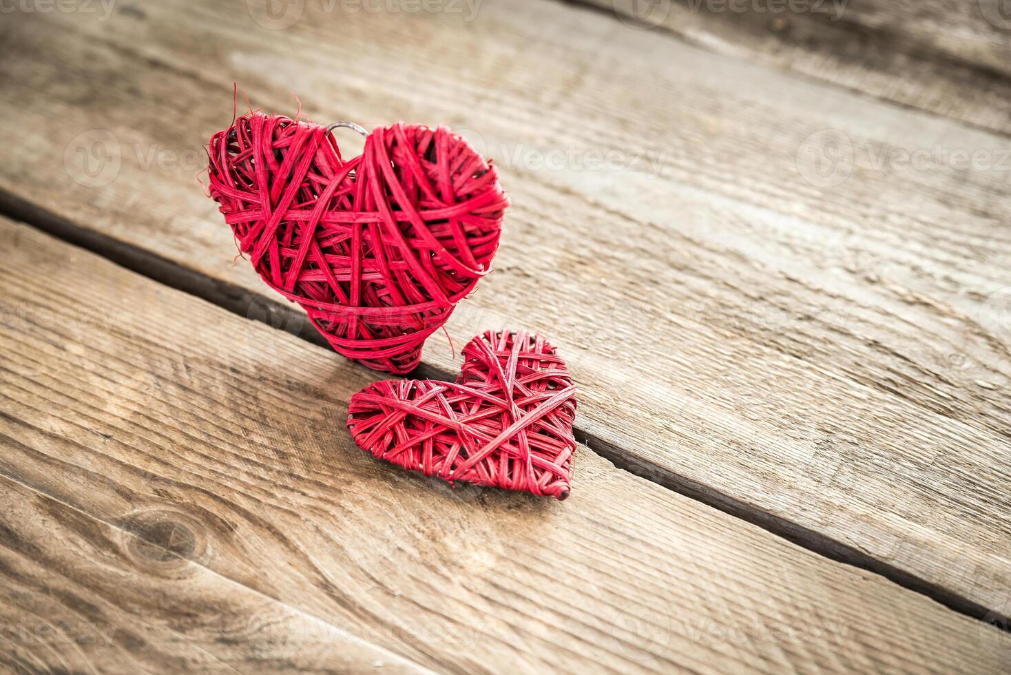 Handmade retro hearts on the wooden background photo