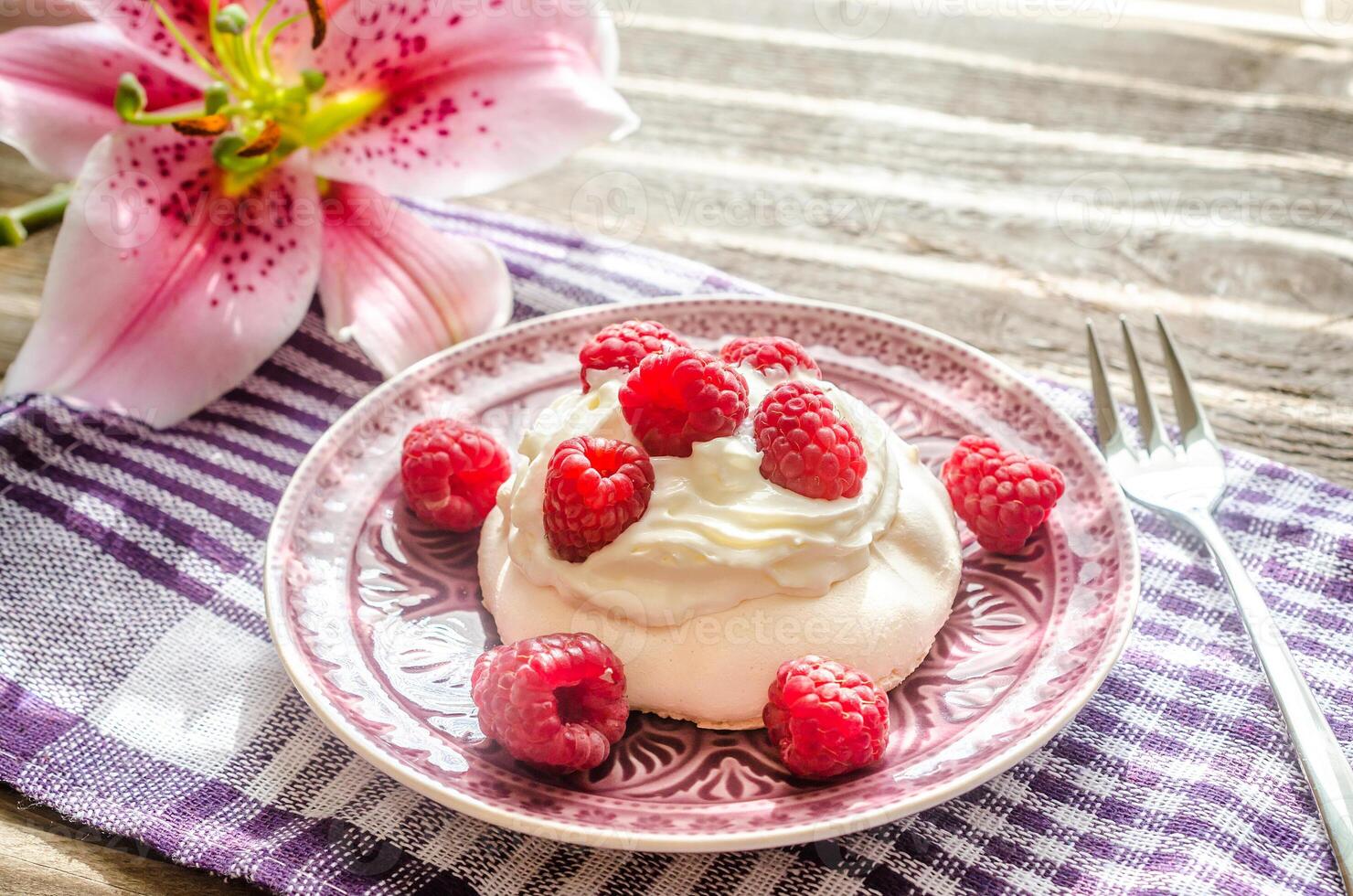 Meringue with fresh raspberries photo