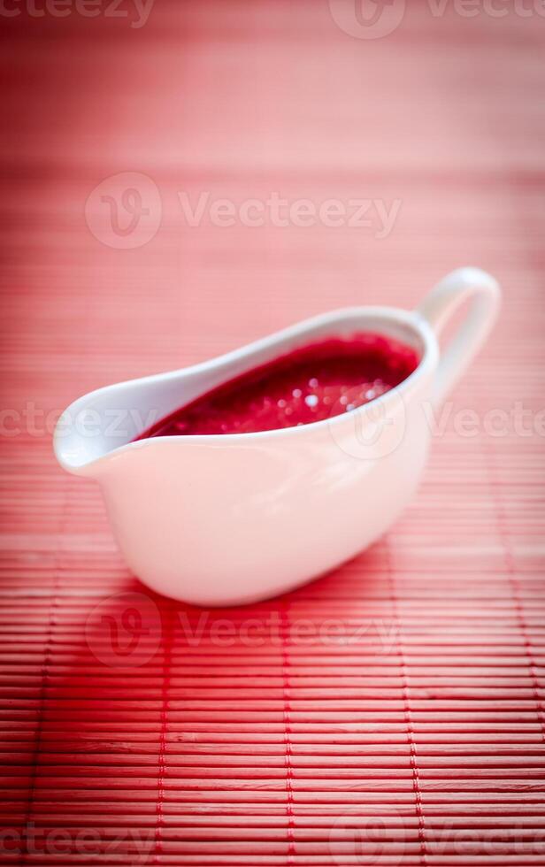 Sauce boat with red sauce photo