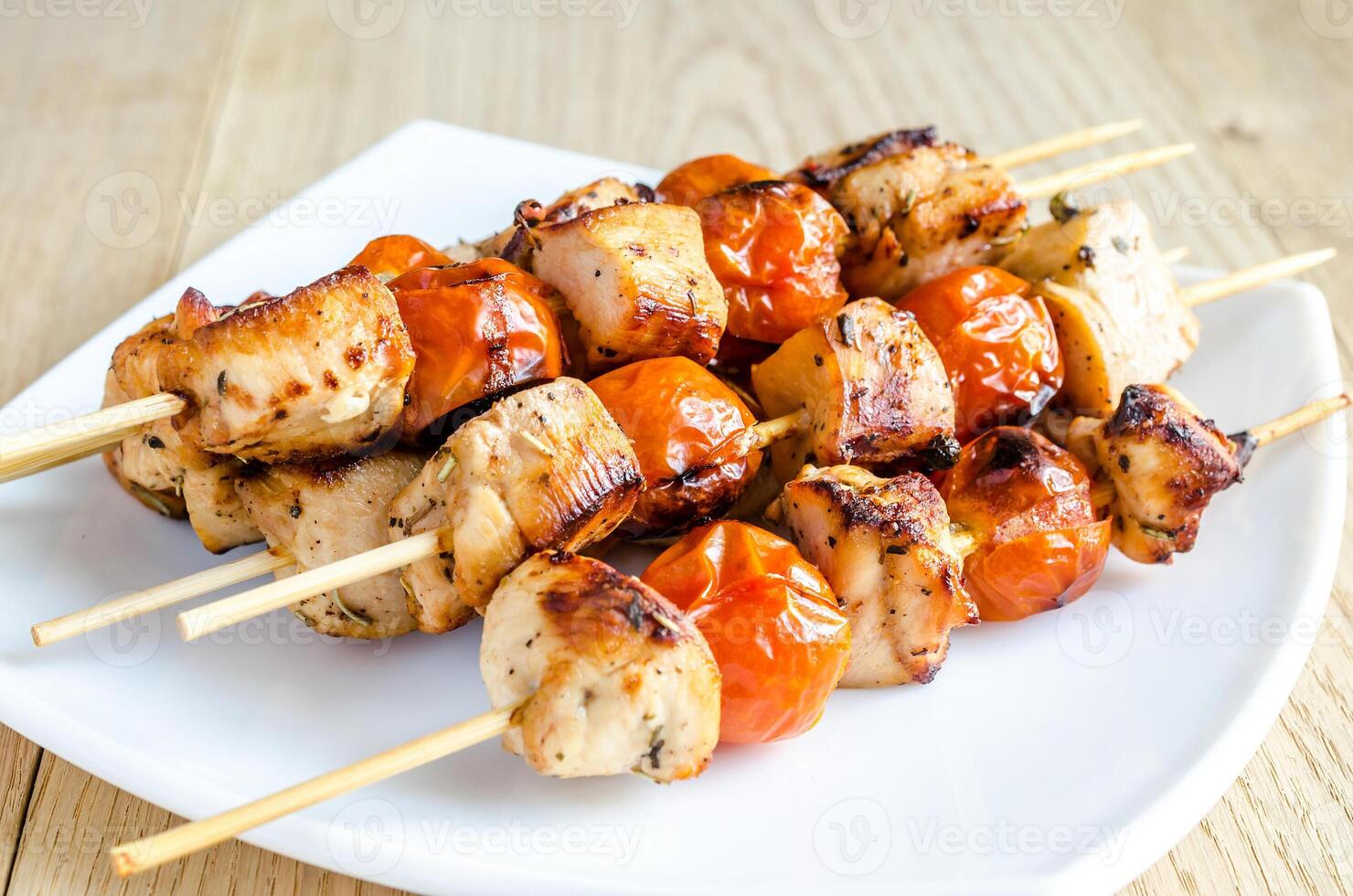 Grilled chicken skewers with cherry tomatoes photo