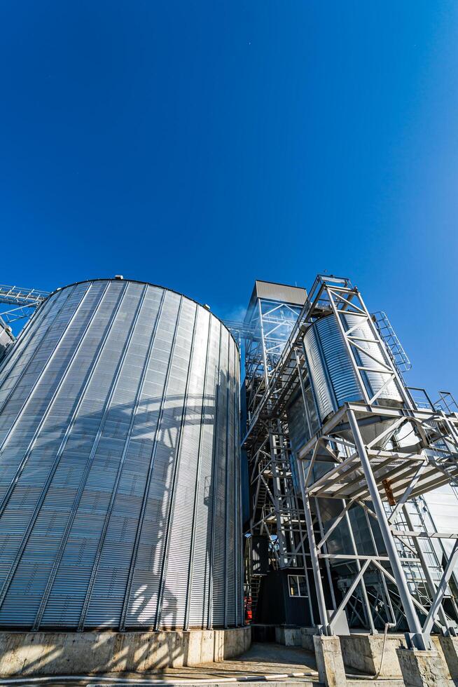 High metal frames in the construction site. Special grain elevators for crop storage. Steel structure is under construction. Selective focus. photo