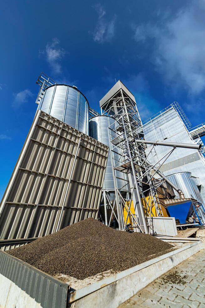 Capacity for keeping rubble dry under big lid. Fire safety equipment near big silos tanks. Closeup. photo