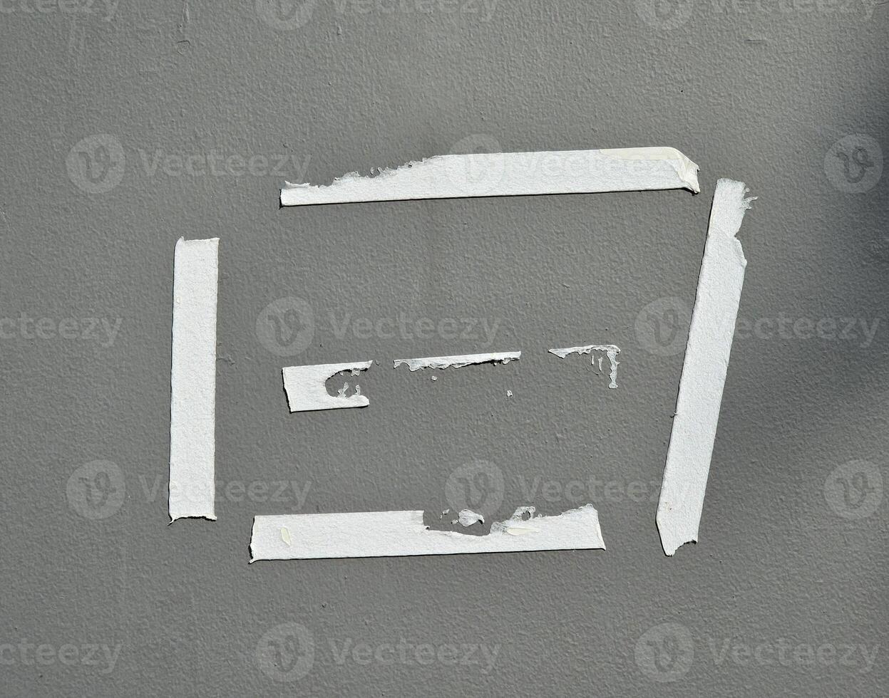 Old glue tape marks on the gray wall photo