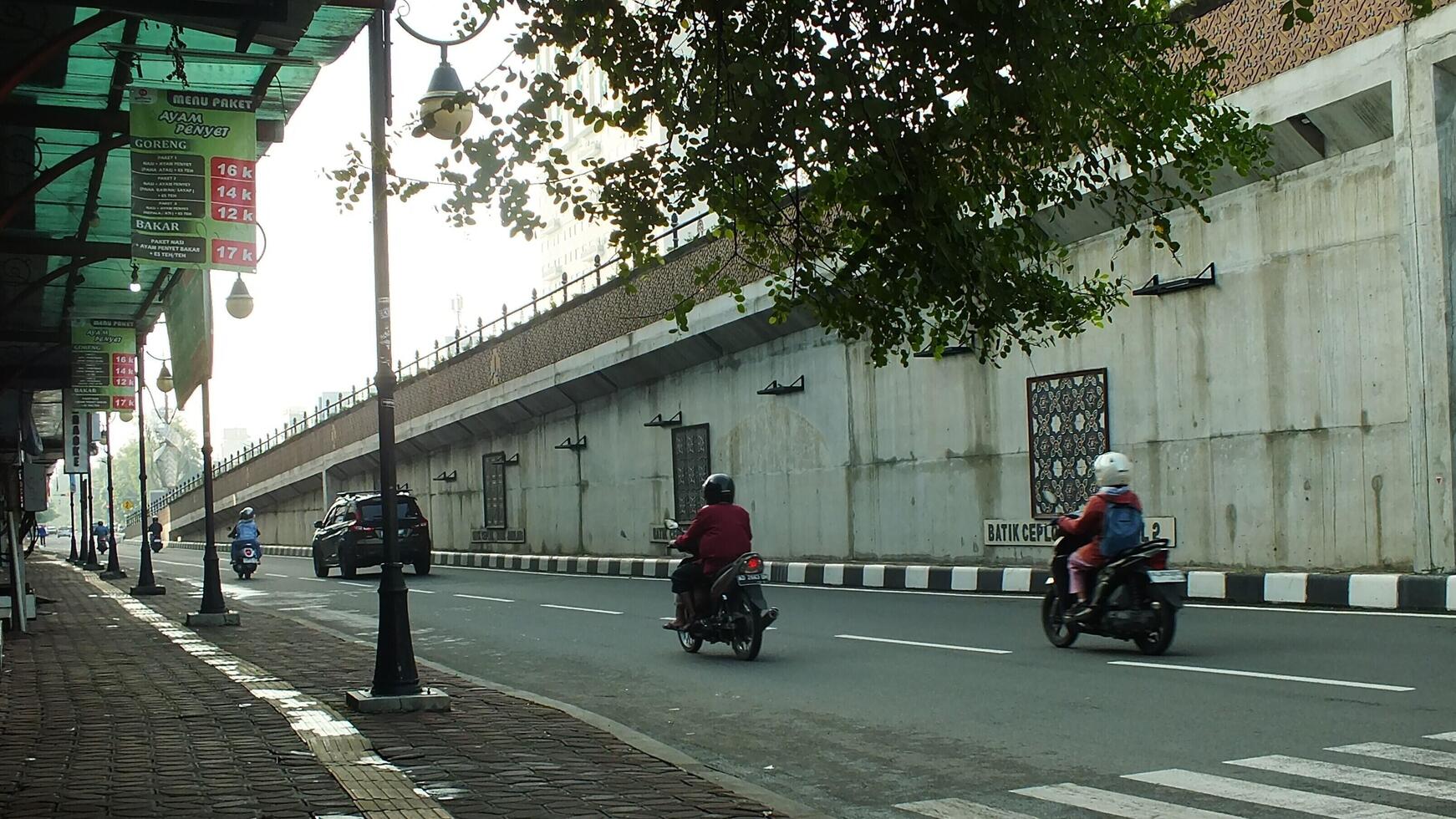 Surakarta, Central Java, Indonesia April 11, 2024. A sight seeing of Main Roads Slamet Riyadi Street in the morning. Not busy yet. People still preparing for their activity photo