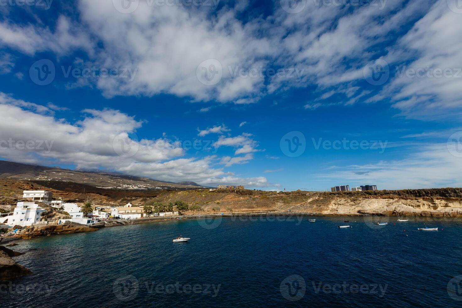 Tropical island of Tenerife. The coast of a Spanish city on the Atlantic ocean. Panorama of the city and beach on the island of Tenerife. Background color with gradient and grain, sound effect photo